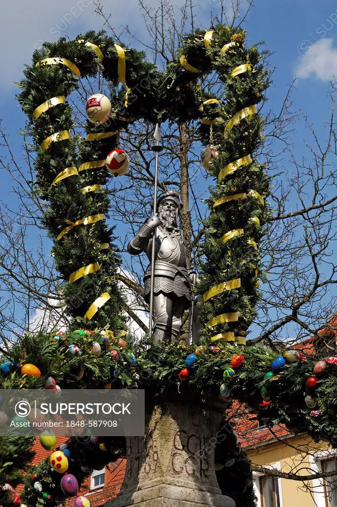 Landsknecht, lansquenet, as a fountain figure with Easter decorations, market square, Graefenberg, Upper Franconia, Bavaria, Germany, Europe