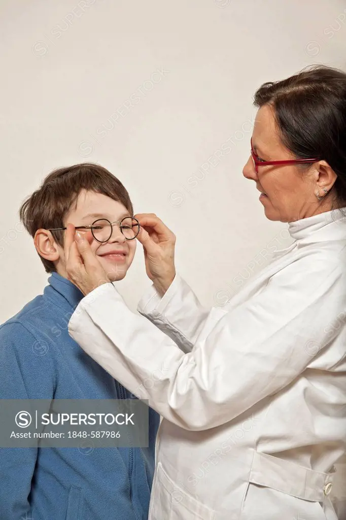 Boy at the eye doctor's, trying on glasses