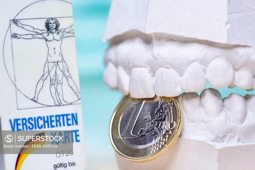 Insurance card, dental plaster cast and a one euro coin, symbolic image for closer monitoring of dentists' invoices by health insurance companies