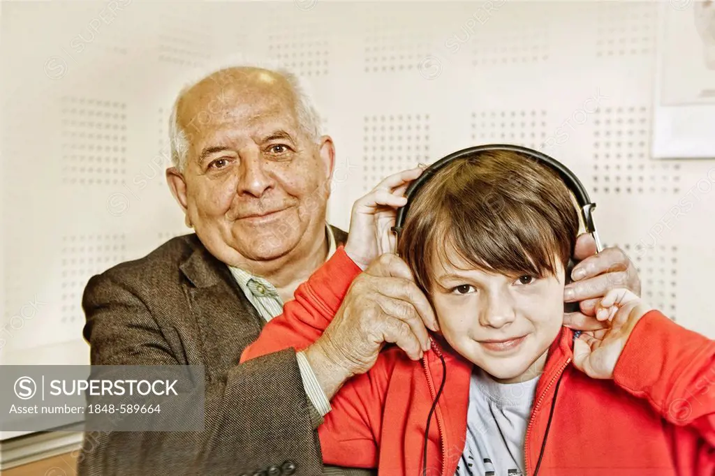 Grandfather and grandson at a hearing test in a laboratory