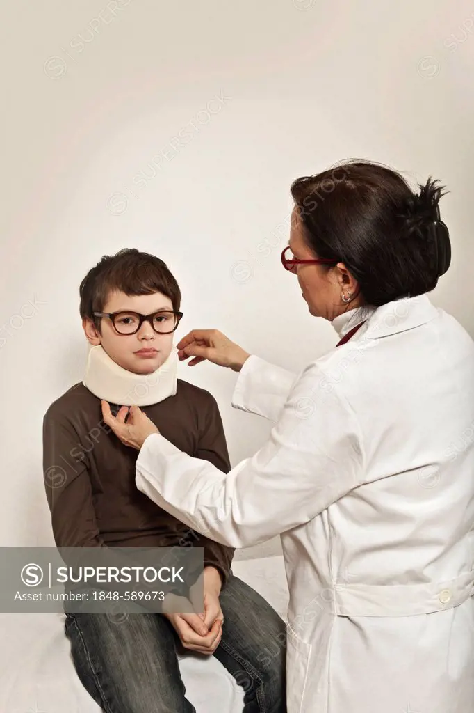 Boy wearing a cervical support being examined by a pediatrician, whiplash