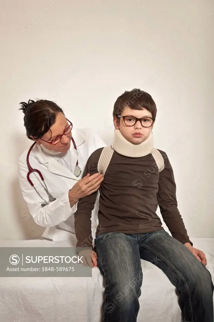 Boy wearing a cervical support being examined by a pediatrician, whiplash