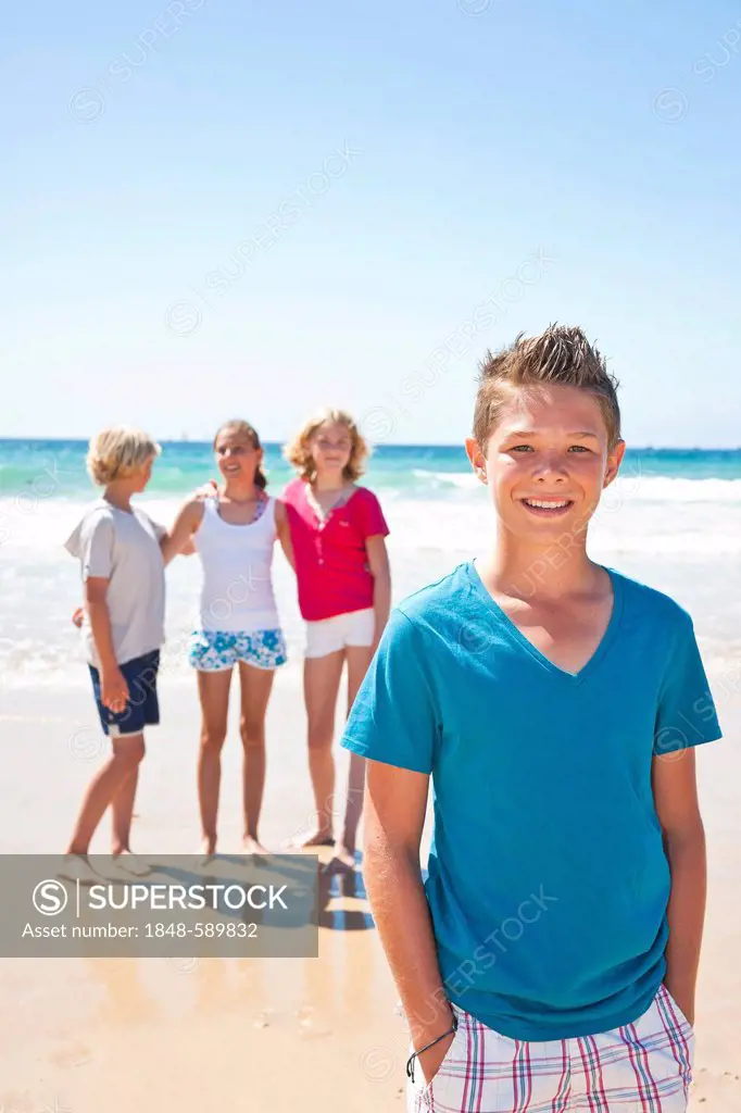Teenagers on the beach, boy in the foreground, Camaret-sur-Mer, Finistere, Brittany, France, Europe