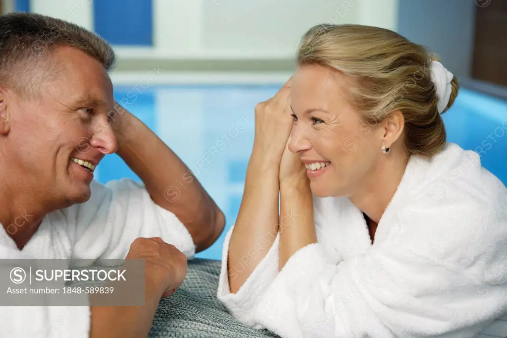 Man, 52 years, and woman, 42 years, talking and smiling, wellness