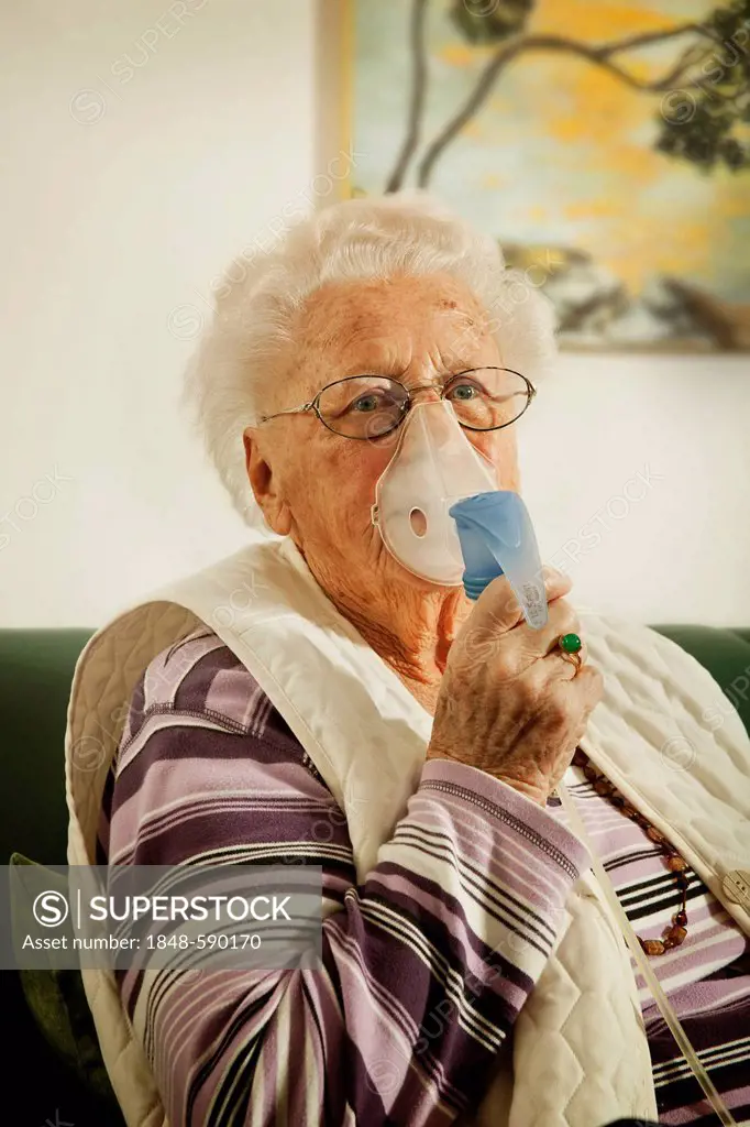 Elderly woman with an inhalator at a nursing home
