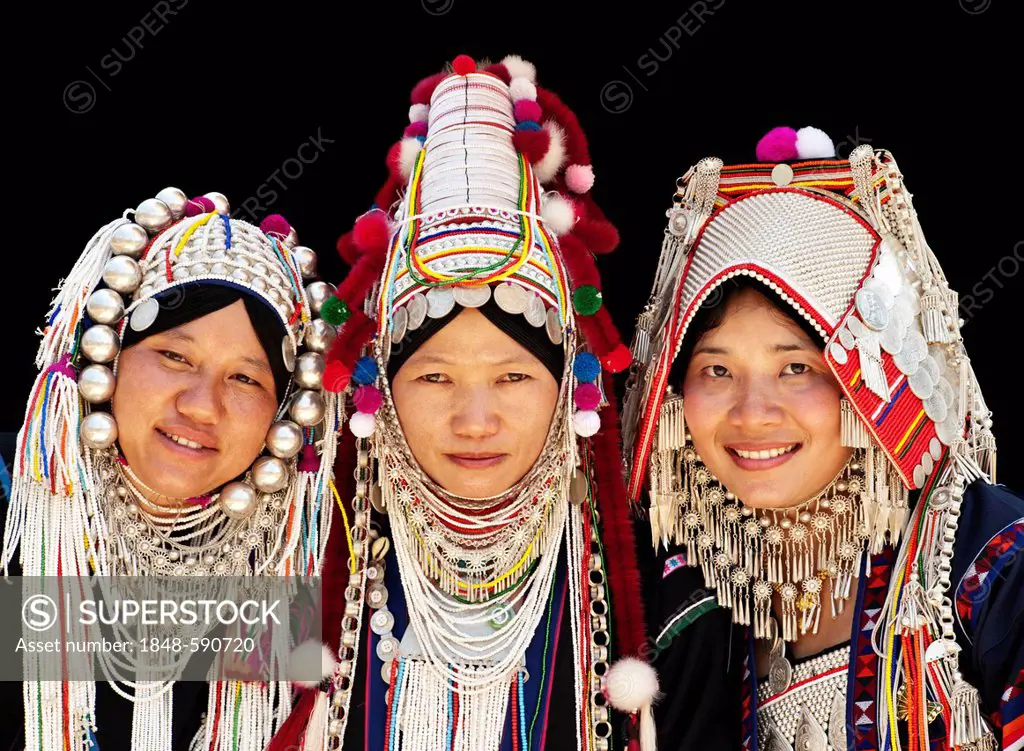 Three women wearing the different Akha head dresses, on the left is the LomueAka style, in the center is the UloAkha style and on the right is the Pha...