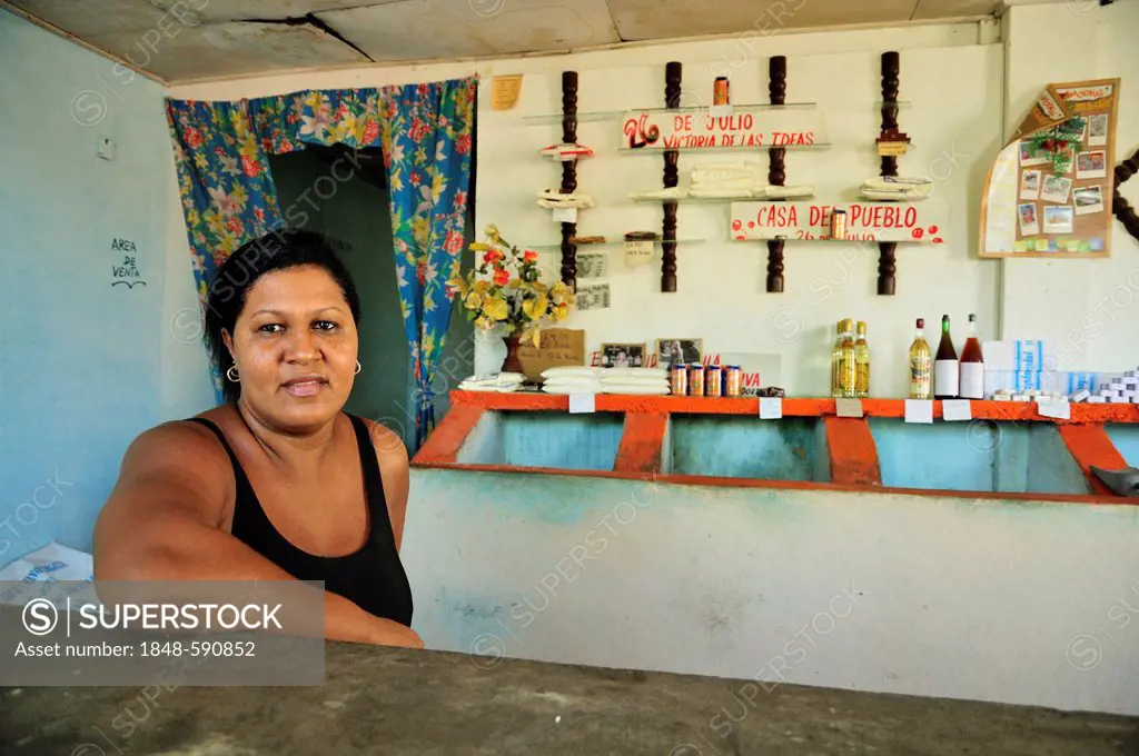 Saleswoman in a bodega, a government store which trades food items for ration coupons, Baracoa, Cuba, Caribbean
