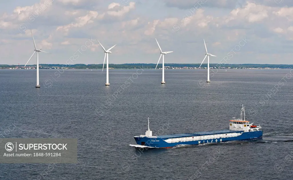 Cargo ship Wilson Astakos sailing in front of an offshore wind farm in the Øresund outside Copenhagen, Denmark, Europe