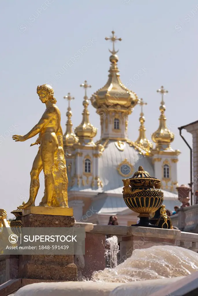 Golden statue of the Grand Cascade in front of onion domes, Peterhof Palace, St. Petersburg, Russia