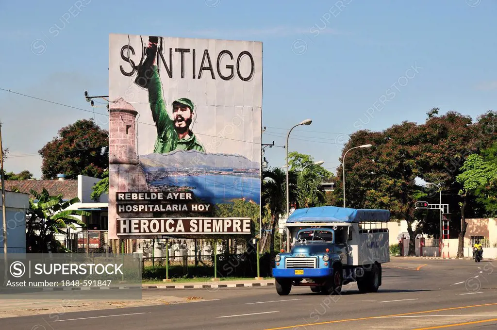 Vintage lorry driving in front of revolutionary propaganda poster, Santiago siempre heróica, Spanish for Santiago is always heroic, Plaza de la Revolu...