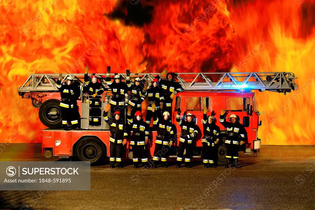 Firemen with a fire engine in front of a fire