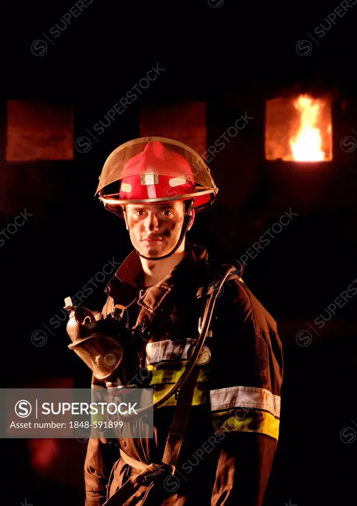 Firefighter in front of a burning building
