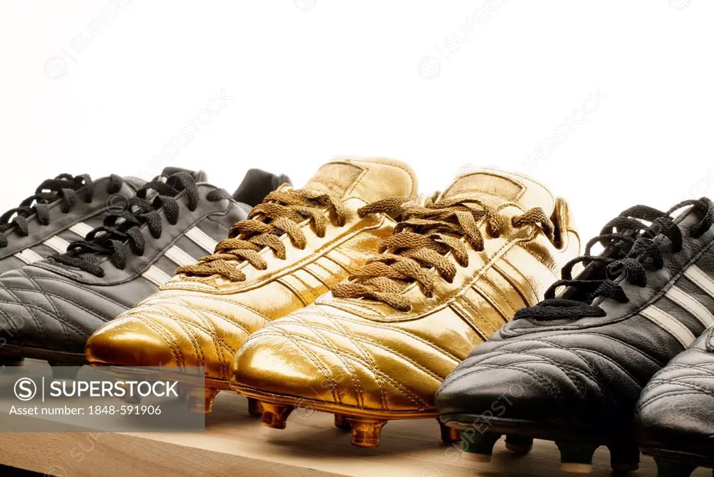 Row of black and gold football boots