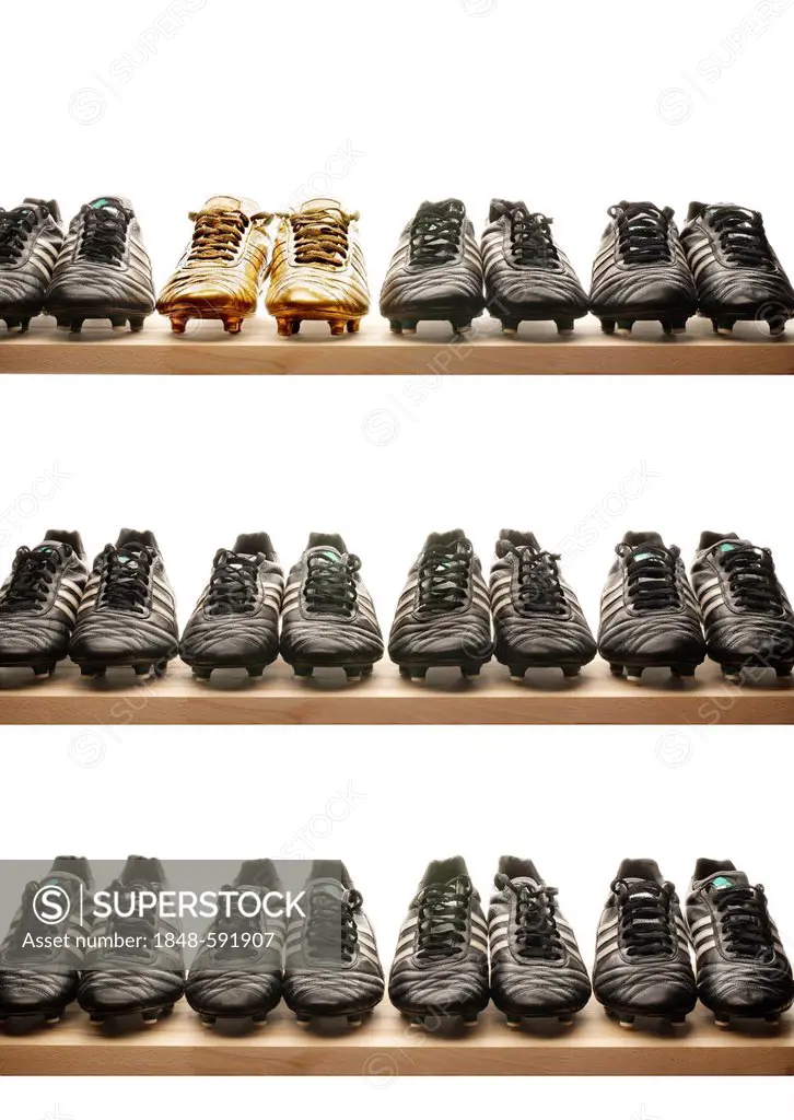 Rows of black and gold football boots on shelves