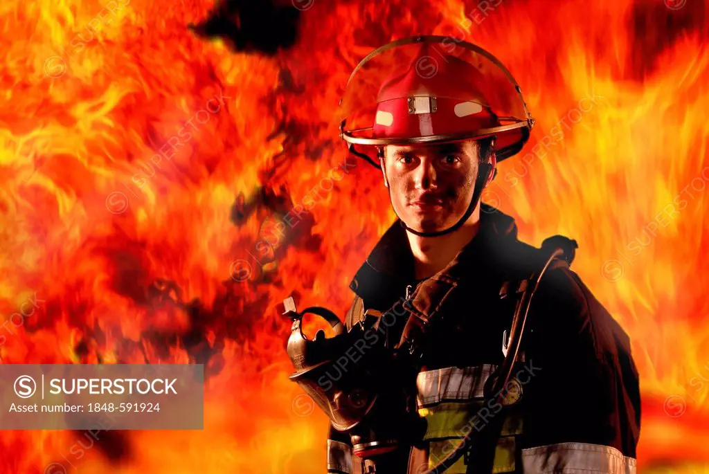 Firefighter in front of a wall of fire