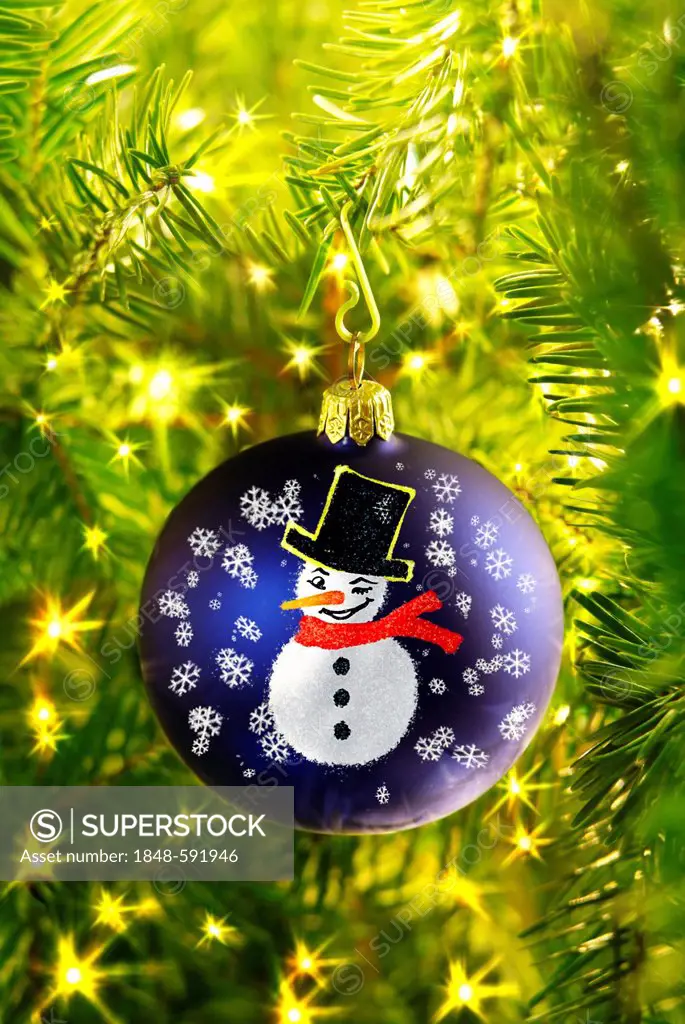 Christmas bauble painted with a snowman on a Christmas tree, Christmas decorations
