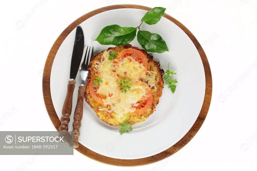 Potato Roesti with slices of tomato and melted cheese
