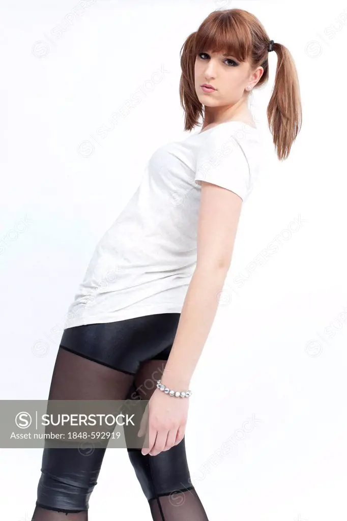 Young woman with pigtails, white shirt and semi-transparent leggings
