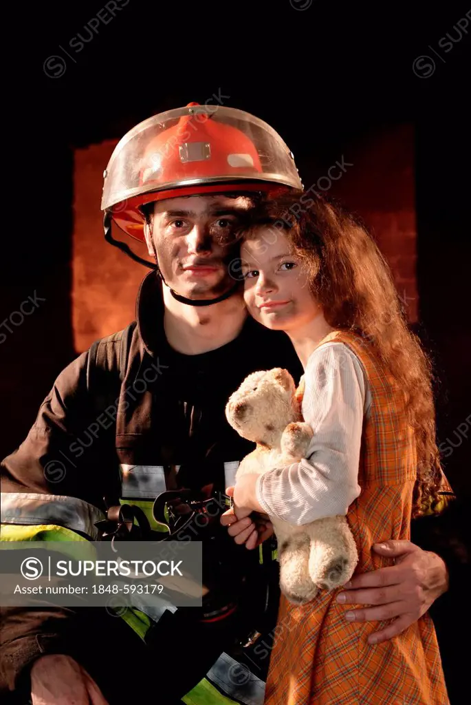 Firefighter with a girl he rescued from a burning building