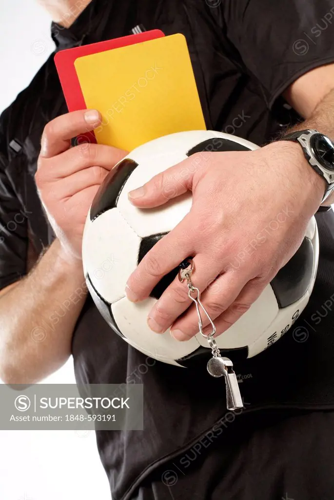 Referee holding a football and red and yellow cards