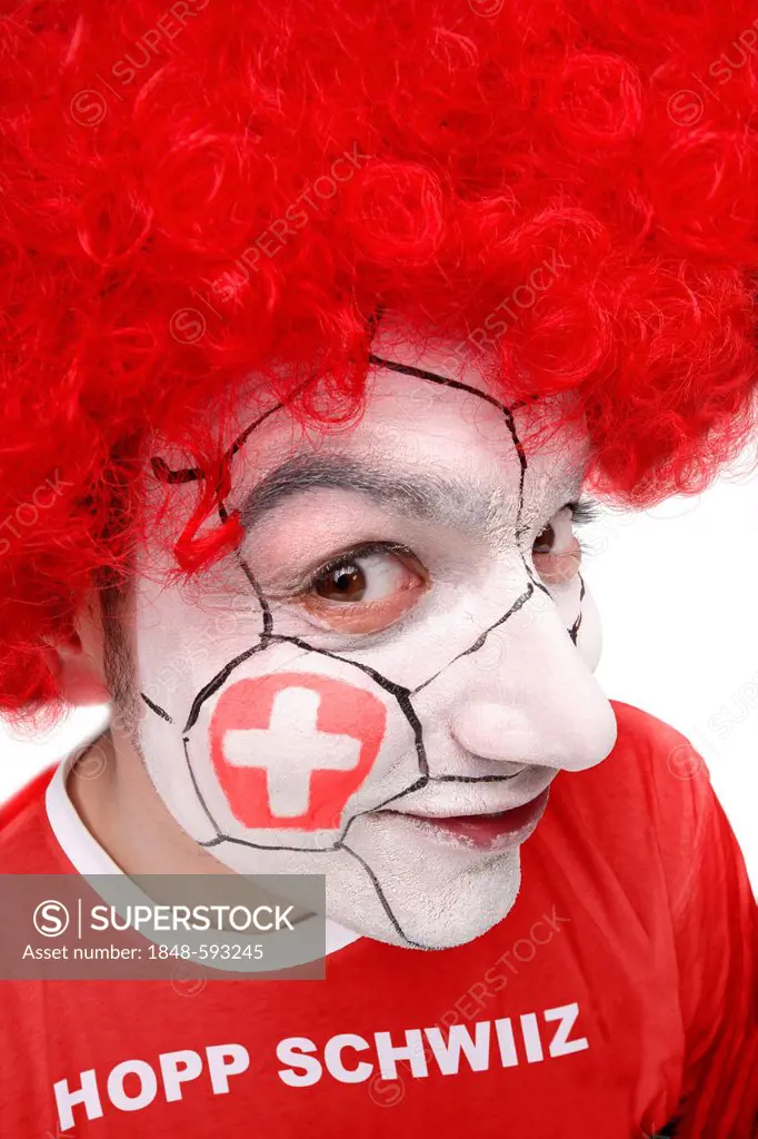Young man, football fan with a painted face, Swiss national flag, wearing a red t-shirt, lettering Hopp Schwiiz, German for Go Switzerland
