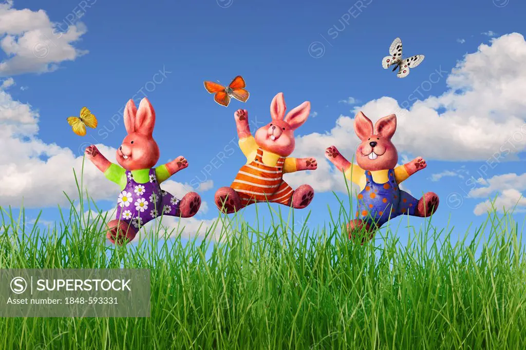 Three Easter bunnies jumping in a meadow, illustration