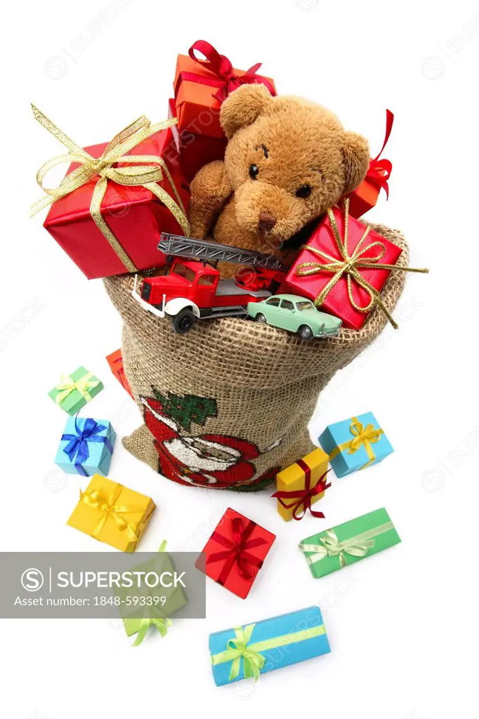 Christms sack filled with Christmas gifts, a teddy bear and toy cars