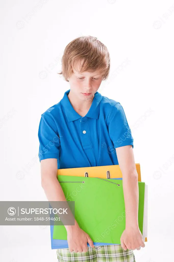 Sad teenage boy with school folders