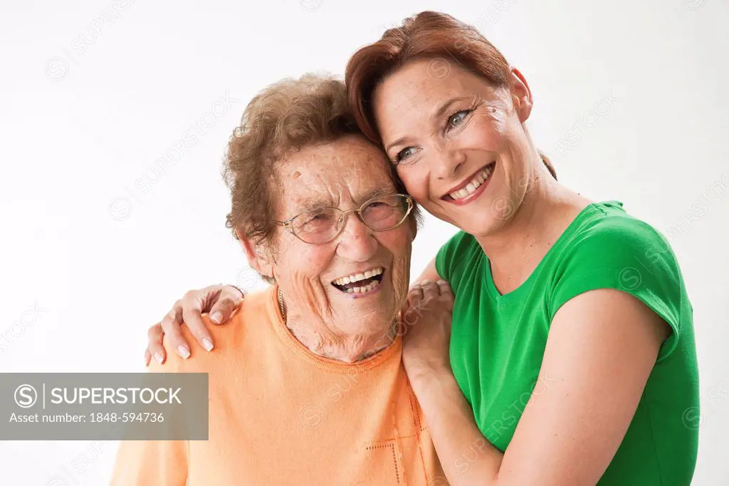 Laughing young woman hugging a laughing older woman