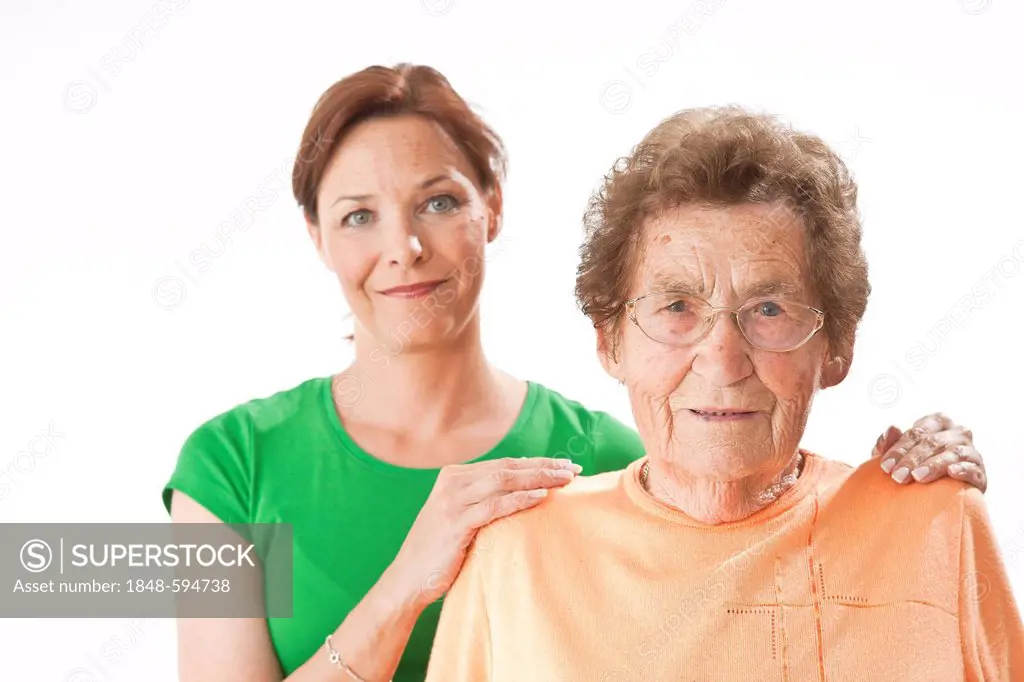 Young woman laying her hands on an older woman's shoulders