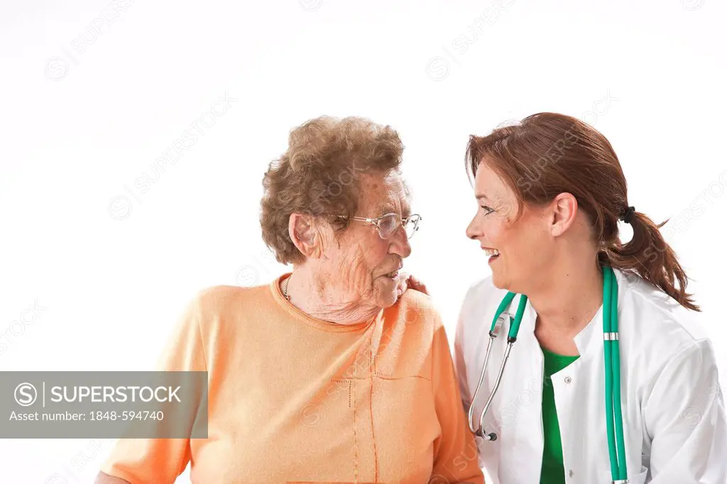 Smiling doctor putting her hand on an elderly woman's shoulder