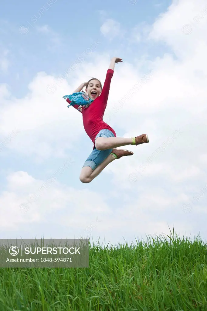 Young girl jumping into the air