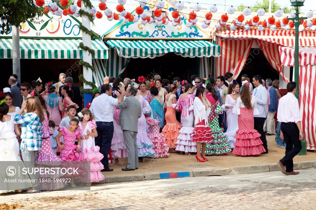 Young women and girls wearing flamenco dresses at the Feria de Abril April Fair in Seville, Andalucia, Spain, Europe