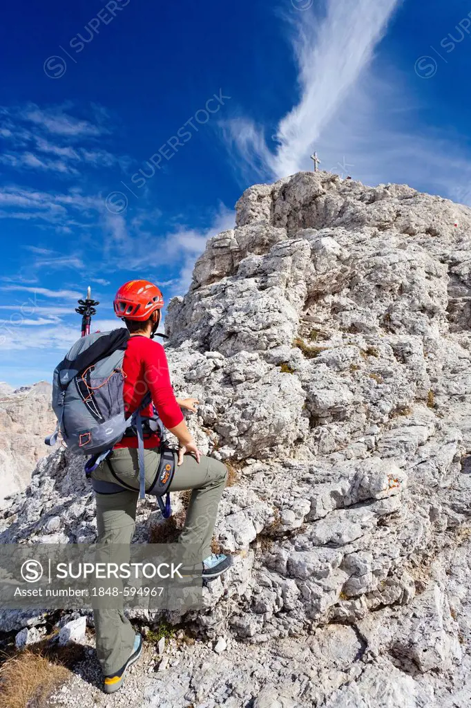 Mountain climber ascending Gran Cir, Grosse Cirspitze Mountain along the climbing route above Gardena Pass, Dolomites, Alto Adige, Italy, Europe