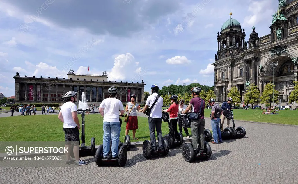 City tour for tourists riding Segways, in front of Berlin Cathedral, Supreme Parish and Collegiate Church in Berlin, and Altes Museum, Lustgarten plea...
