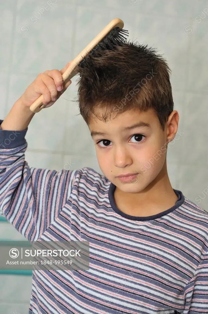 Boy, 5 years, brushing his hair in the bathroom