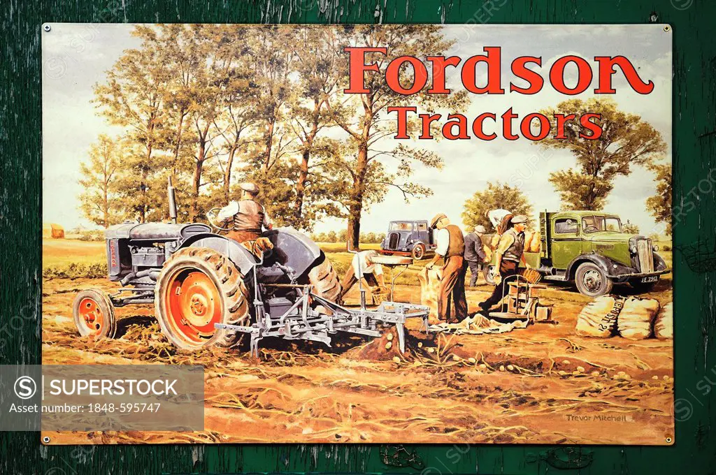 Old English advertising sign for tractors from the 1930s on a wooden wall at the port of Exeter, Devon, England, United Kingdom, Europe