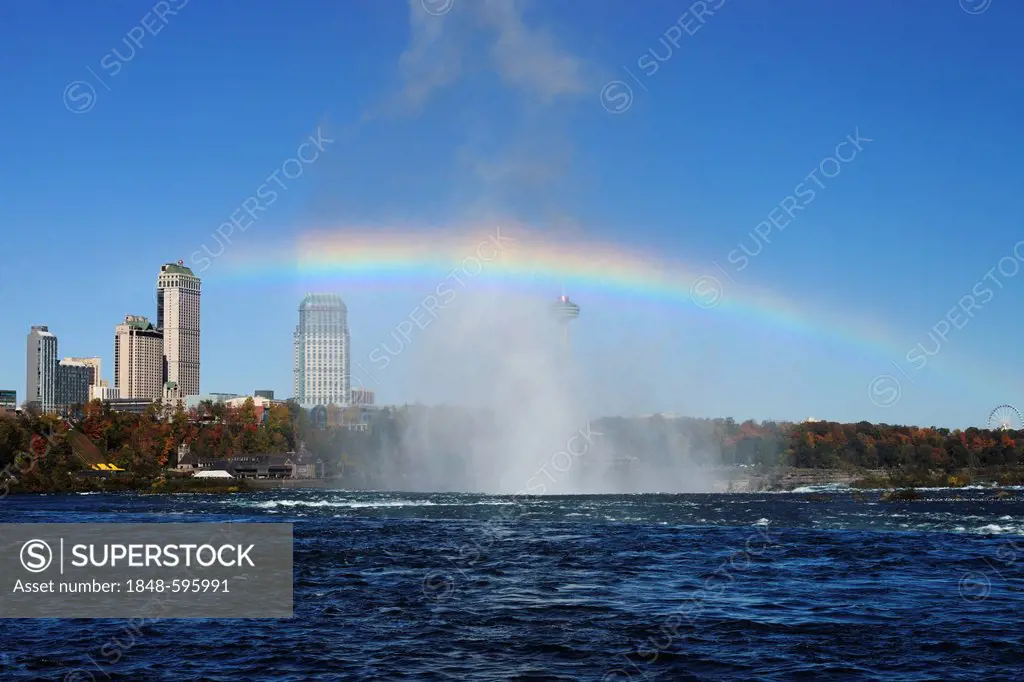 Rainbow over the Niagara Falls with hotels, Niagara Falls, Ontario, Canada, North America