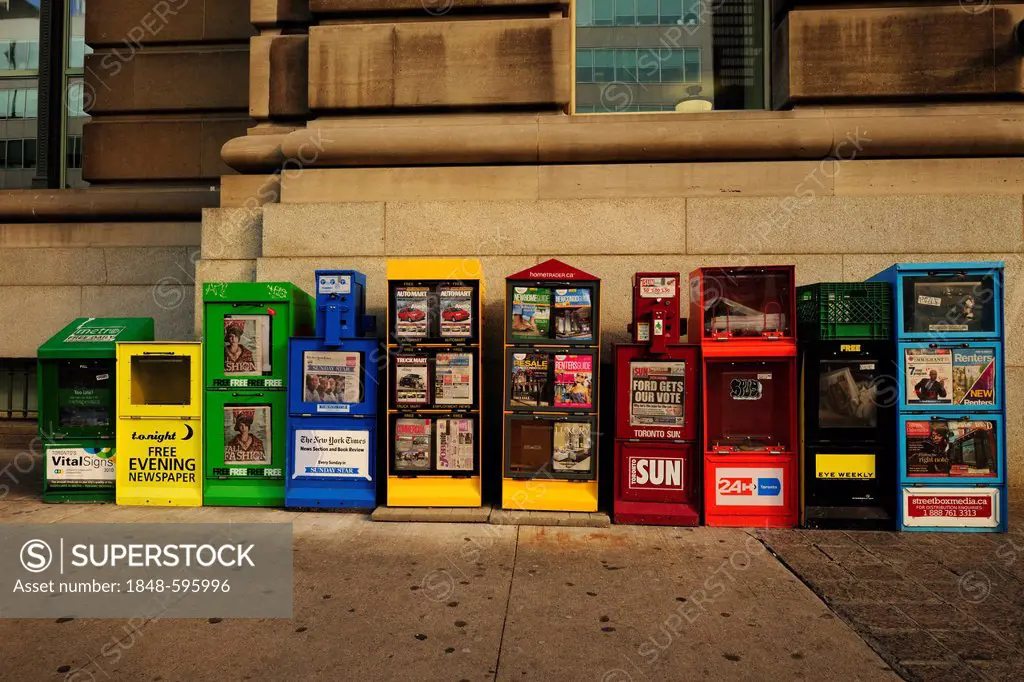 Magazine racks with free newspapers side by side, Toronto, Ontario, Canada, North America