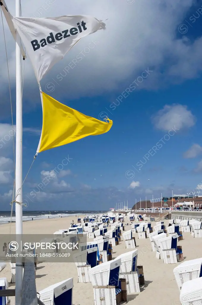 Flag Badezeit or swimming time and roofed wicker beach chair on the beach in Westerland, Sylt, North Frisian Island, Germany, Europe
