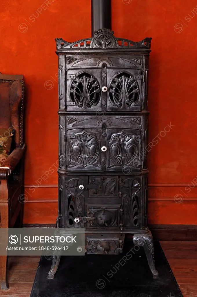 Cast iron stove, circa 1900, living room in the teacher's apartment, school building from Pfaffenhofen, built in 1801, Franconian open-air museum, Eis...