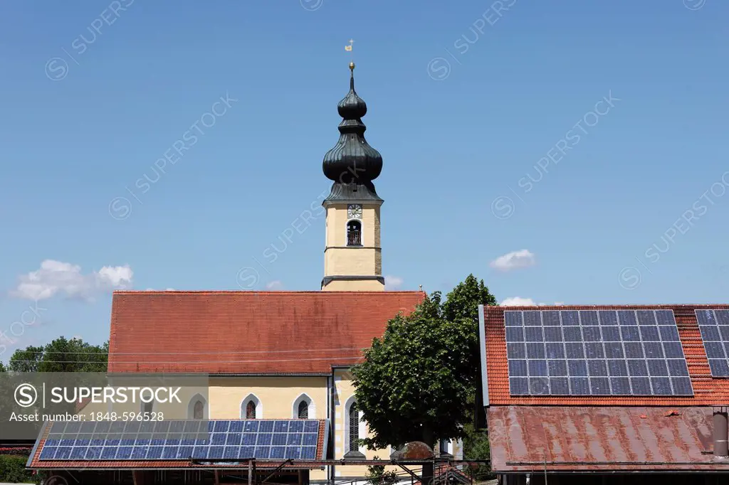 Church of the Nativity behind barnroofs with solar panels, Frauenried, Irschenberg district, Upper Bavaria, Bavaria, Germany, Europe