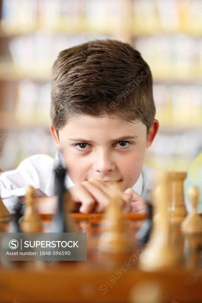 Concentrated boy playing chess