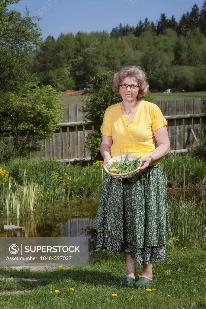 Woman holding herbs in a basket