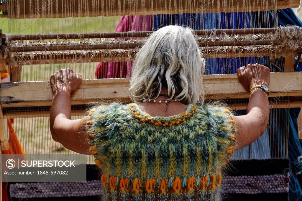 Woman working on a wooden hand loom, Flachsmarkt historical crafts market, Krefeld-Linn, North Rhine-Westphalia, Germany, Europe