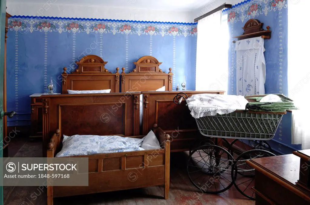 Bedroom, in front cradle and baby carriage, 1935, teacher's apartment in a school building from Pfaffenhofen, built in 1801, Franconian open-air museu...