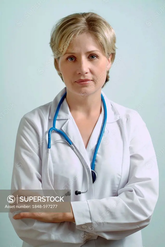 Female doctor, physician, 30-40 years, crossed arms, looking serious