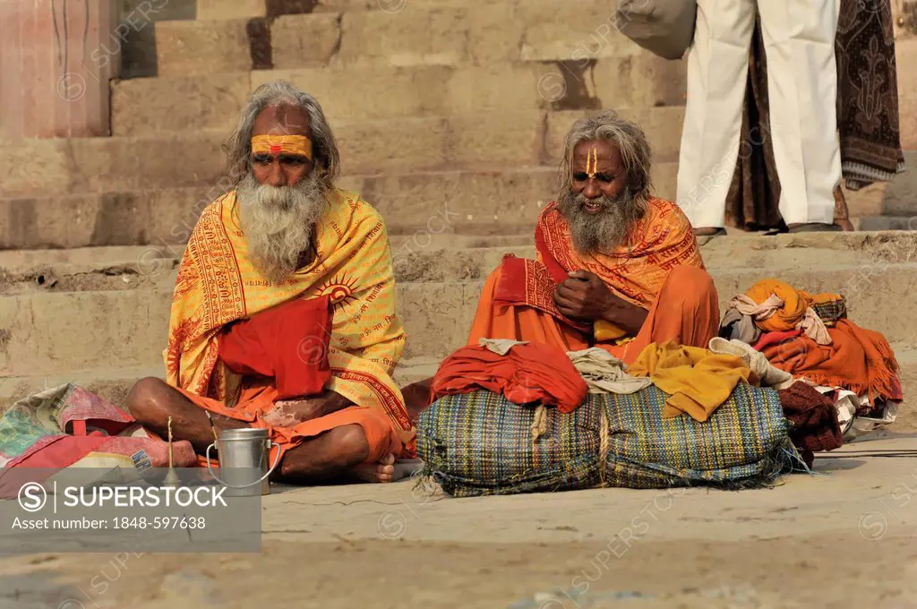Sadhus on a ghat or steps on the banks of the Ganges in Varanasi, Benares, Uttar Pradesh, India, South Asia