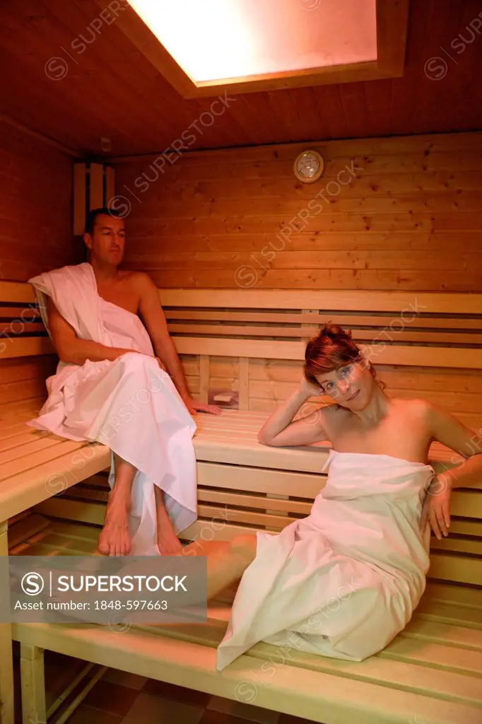 Couple sitting in a sauna