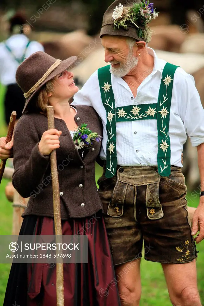 Couple wearing traditional costume during Viehscheid, separating the cattle after their return from the Alps, Thalkirchdorf, Oberstaufen, Bavaria, Ger...